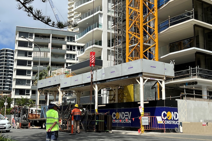 A construction site in the Gold Coast with CONDEV signing, people in high visibility vests walking around