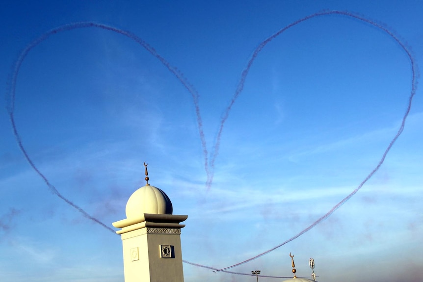 The Patrouille Acrobatique de France team leave a smoke trail in the shape of a heart.
