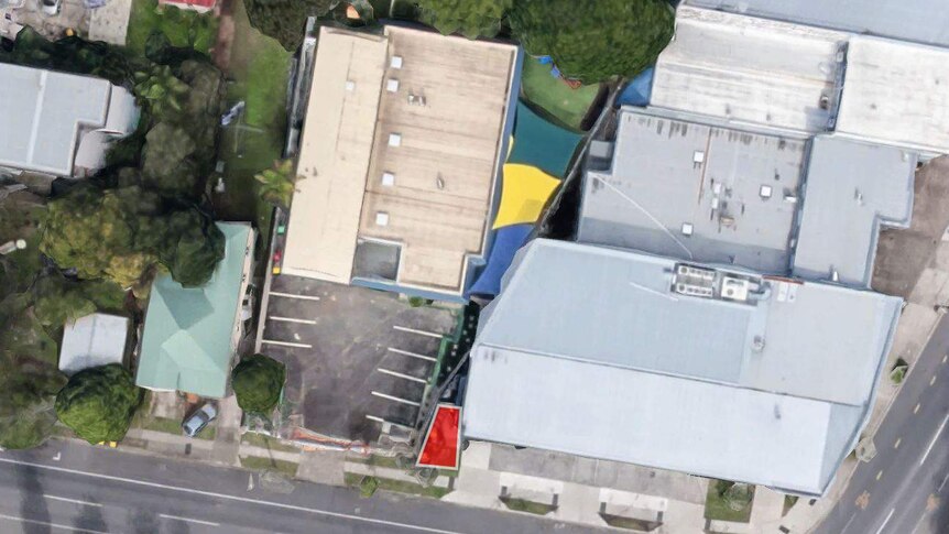 Satellite image showing the proximity of the smoking are to the child care's play areas.
