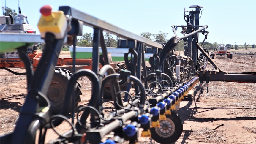 Robotic spray rig stands in paddock.