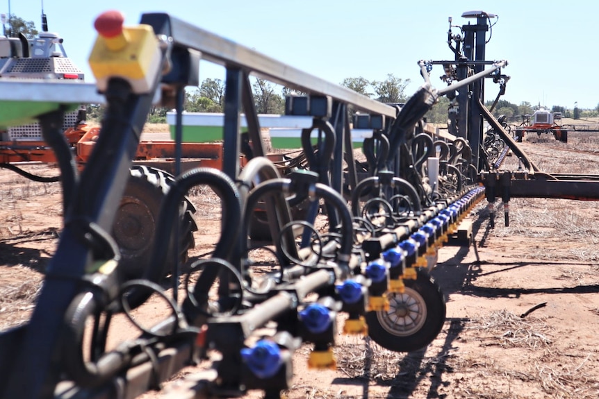 Robotic spray rig stands in paddock.