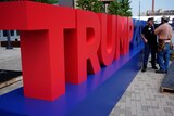 Bright red letters are erected to spell 'Trump'.