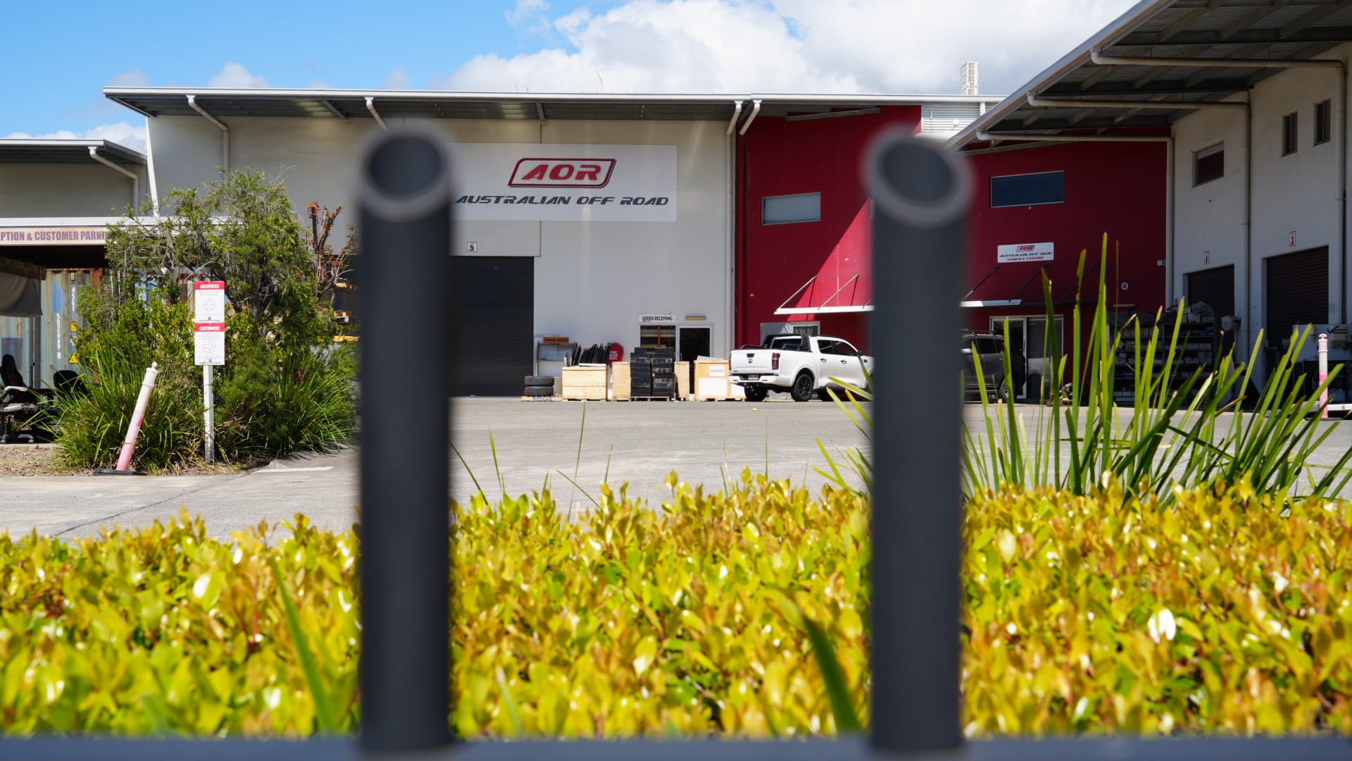 The AOR warehouse pictured through a fence