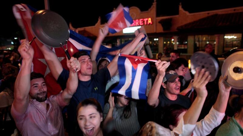 People wave Cuban flags, some bang pots and pans in celebration on the streets