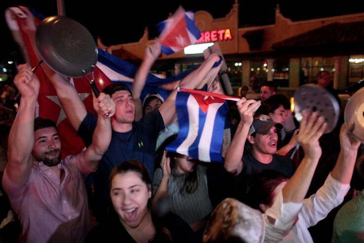 People wave Cuban flags, some bang pots and pans in celebration on the streets