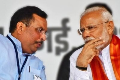 Two men lean in to talk to each other, with one man wearing a red and white robe.