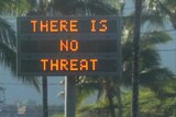 An electronic sign beside a road reads "There is no threat"