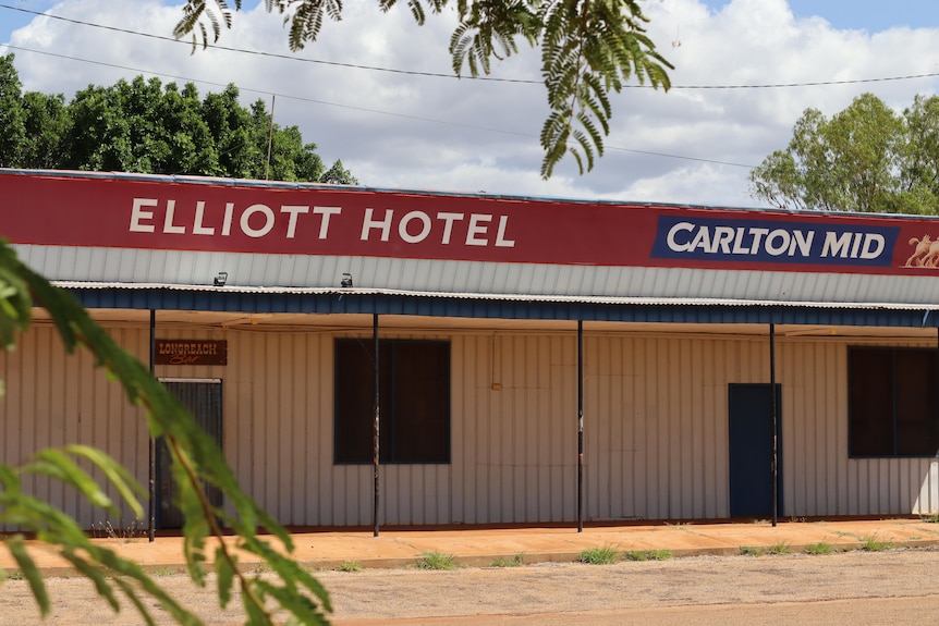A low outback building with the roof advertising it as the "Elliott Hotel".