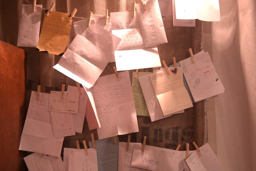 Handwritten letters pegged to a string