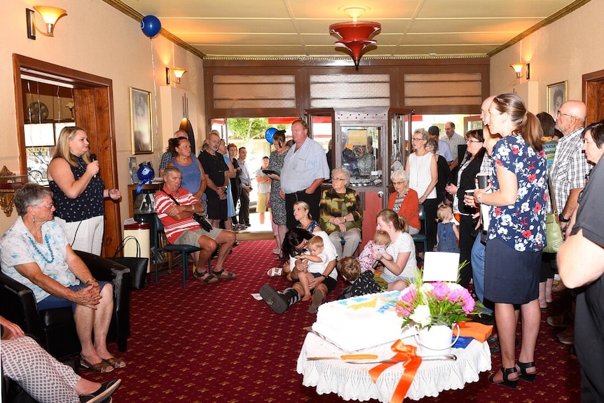 A crowd of people standing in a room.