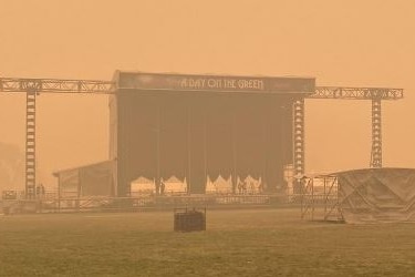 An outdoor stage immersed in smoke.