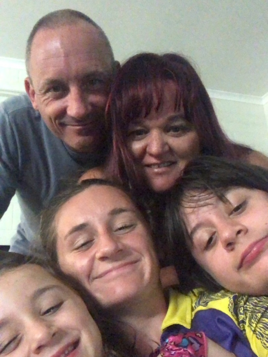 A photo of Nhulunbuy-based New Zealand woman Angela Hughes hugging her family.