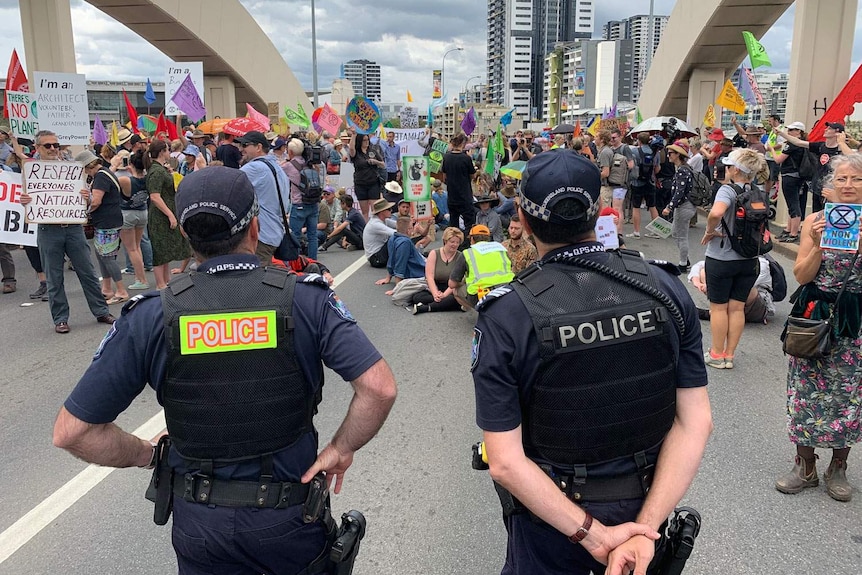 William Jolly Bridge in Brisbane's CBD blocked by hundreds of climate change protesters with police looking on.