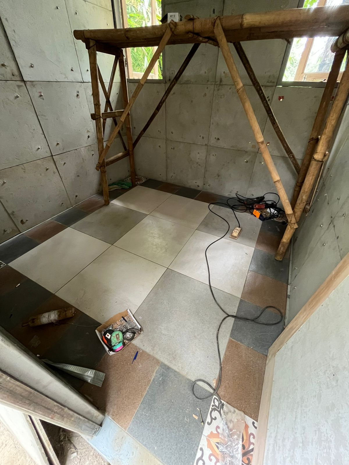 Concrete floor in square tiles.