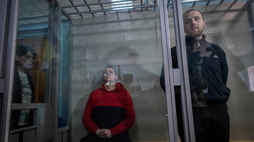 Russian soldiers Alexander Alexeevich Ivanov and Alexander Vladimirovich Bobykin attend their trial hearing in Kotelva.