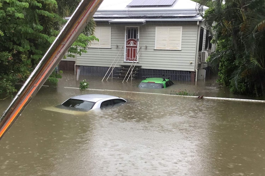 Flooding showing submerged cars and houses in Lindsay Street in Rosslea in Townsville on February 2, 2019.