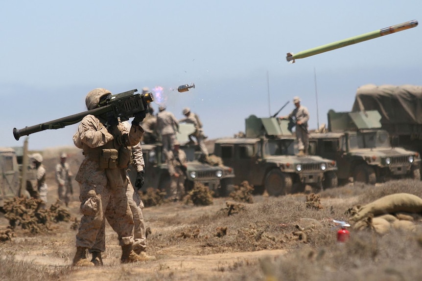 A soldier fires a Stinger missile into the air.