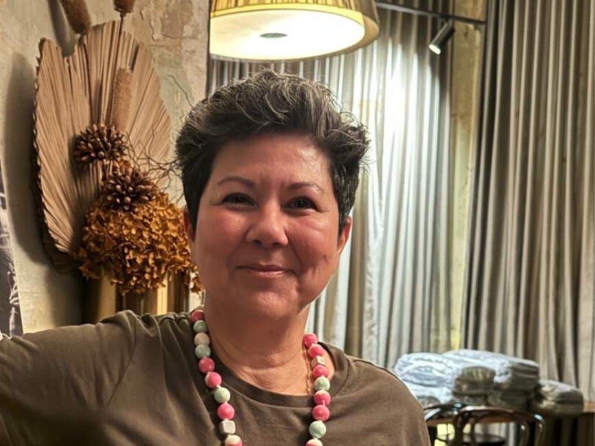 A close up of a smiling woman.