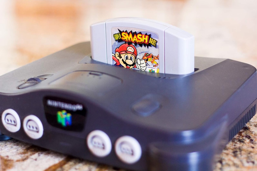 A Nintendo 64 console with a Super Smash Bros game.