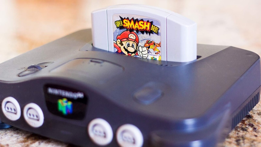 A Nintendo 64 console with a Super Smash Bros game.