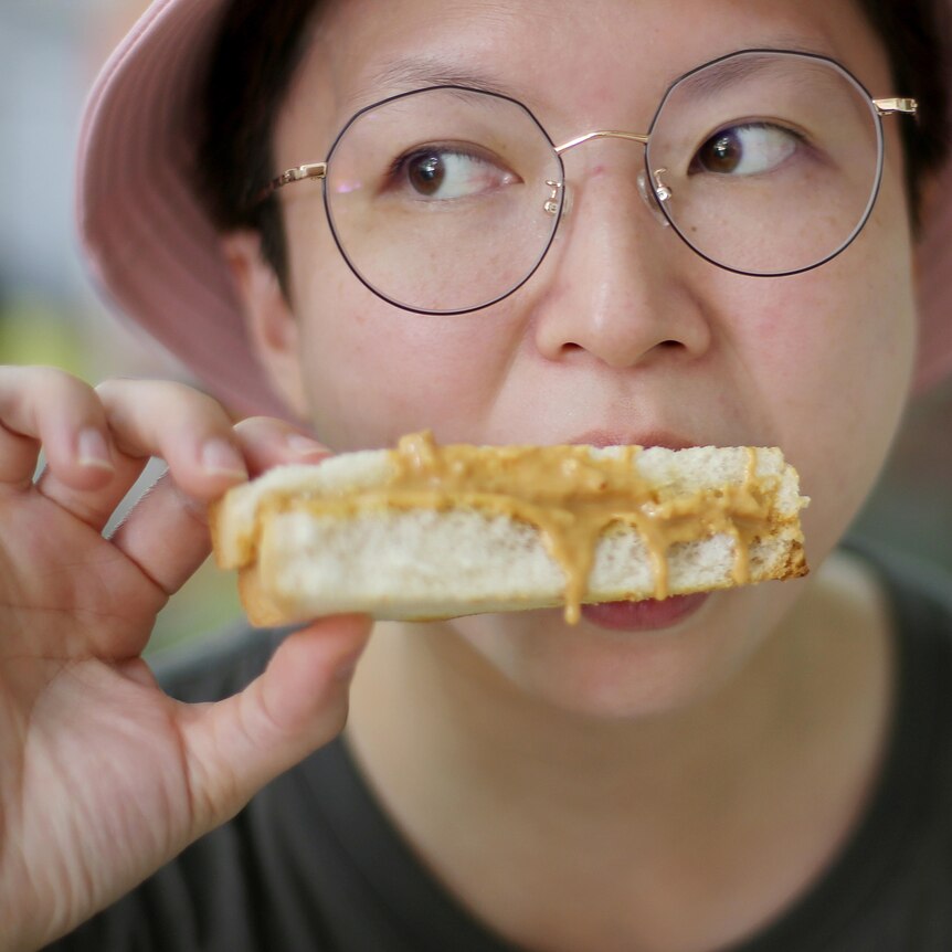 Woman eating a peanut butter sandwich