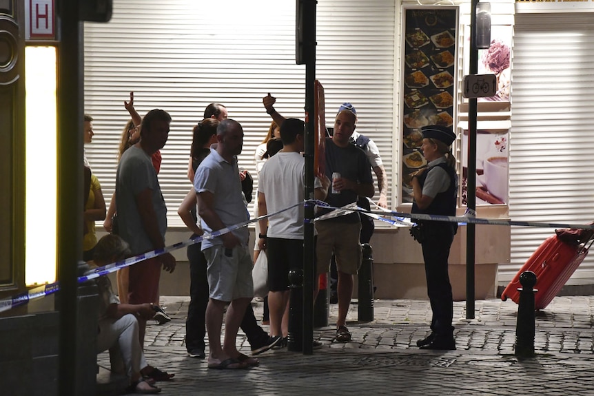 Members of the public speak with police