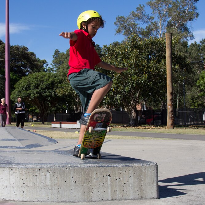 A boy practises in skateboarding skills in Redfern Park