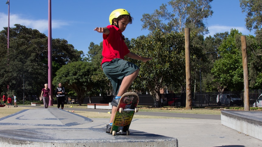 A boy practises in skateboarding skills in Redfern Park