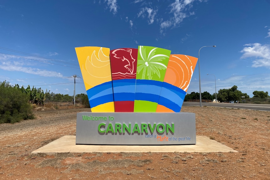 A multicoloured sign reading "Carnarvon a taste of the great life."