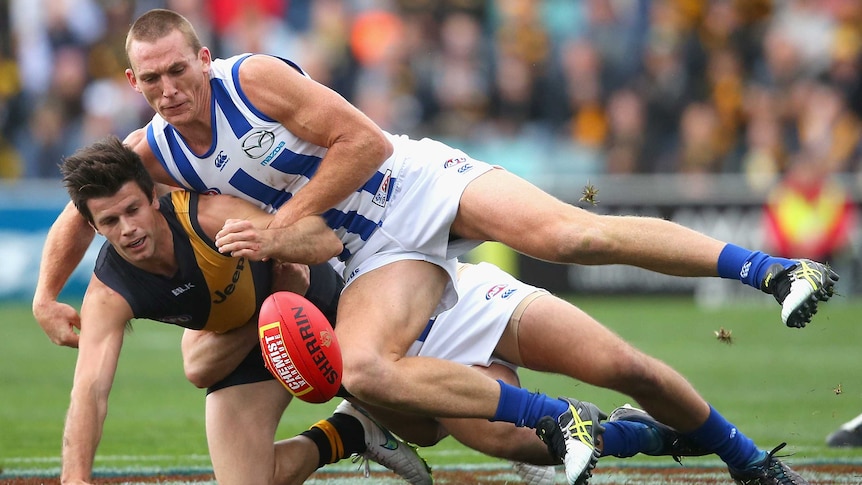 Luke McDonald tackles Trent Cotchin