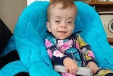 a baby boy in a big blue chair