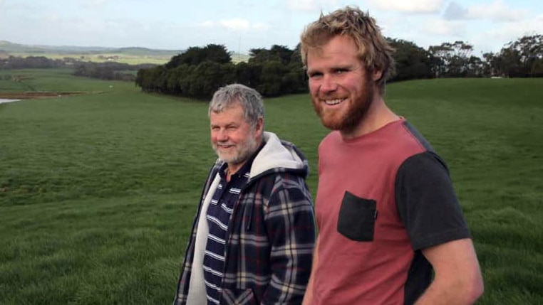 Ross and Andy Powell standing in a field.