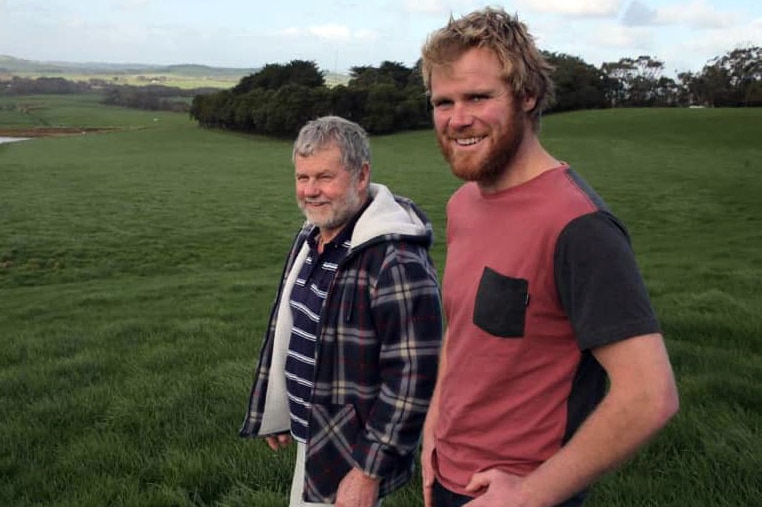 Ross and Andy Powell standing in a field.