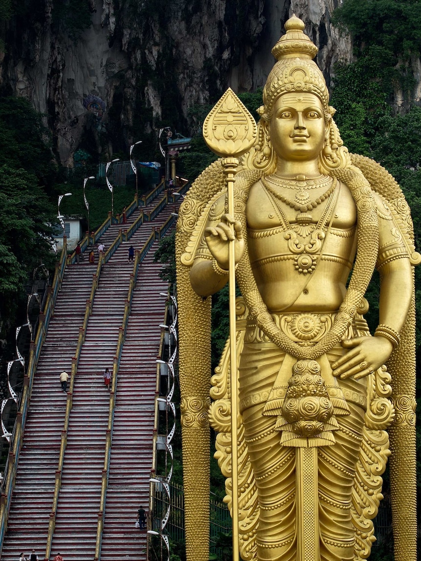 Tourists walk up stairs to Batu Caves in Malaysia
