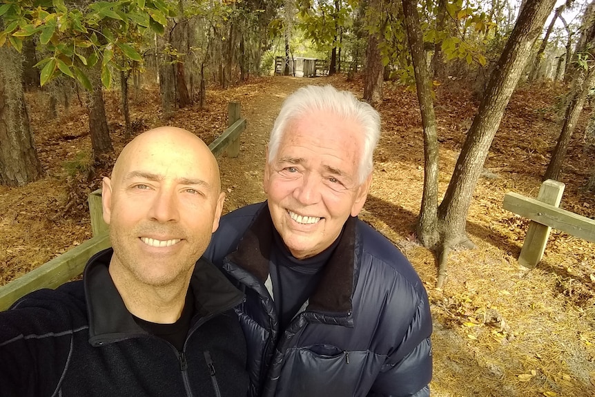 Father and son taking a selfie in a forest. 