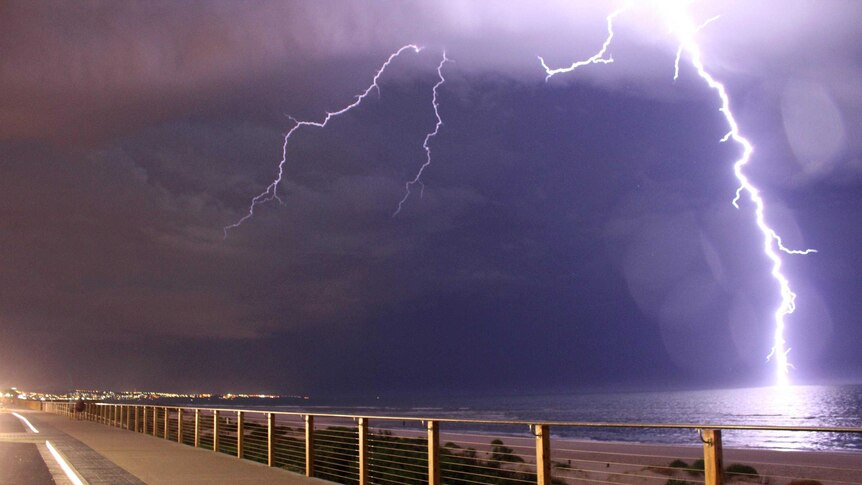 Lightning strikes the water off Henley Beach.