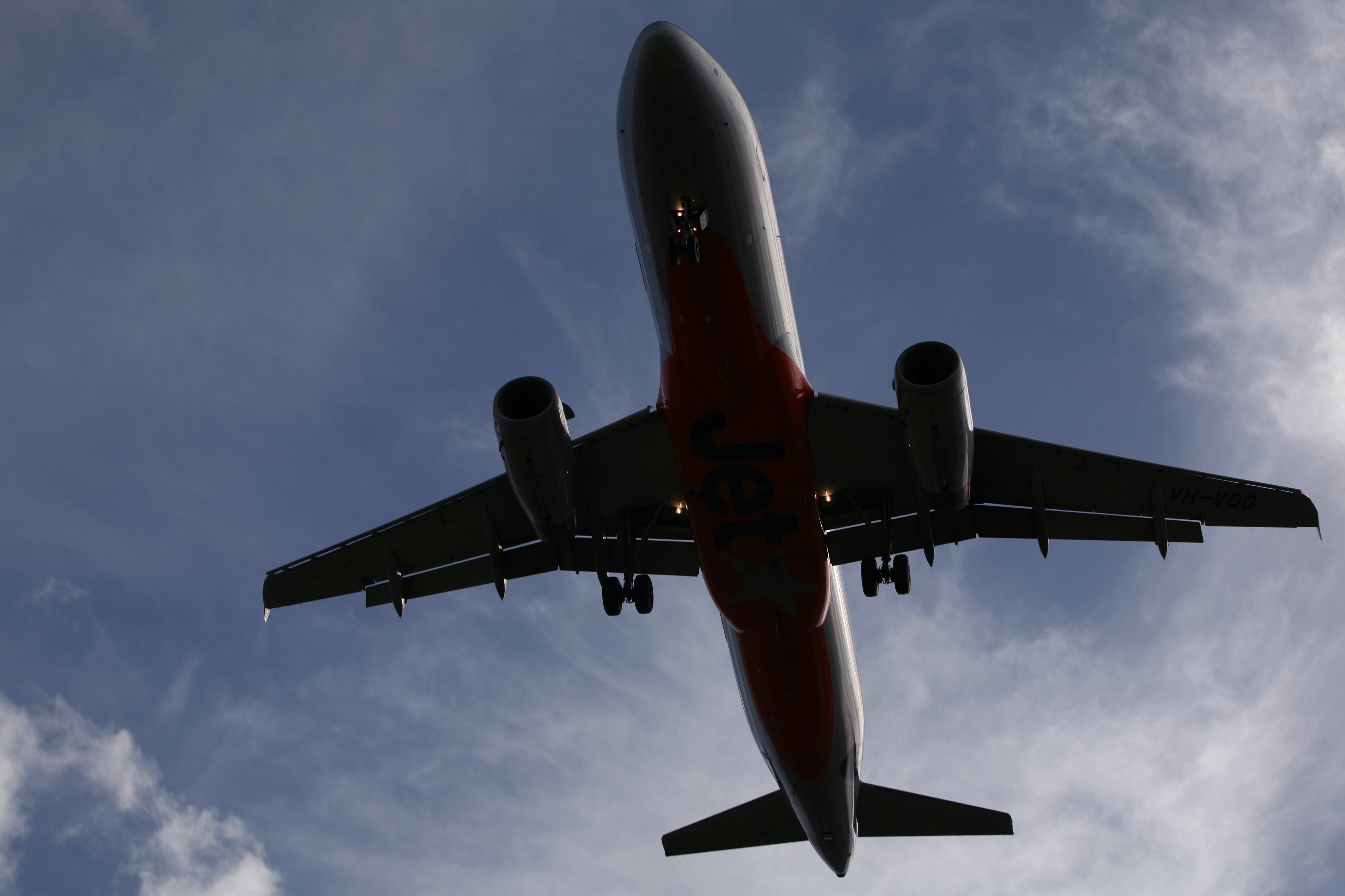 A Jetstar twin engine jet makes its final approach to Sydney Airport