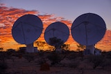 Under a sunset sky, three ASKAP telescopes are trained towards the sky east of Geraldton