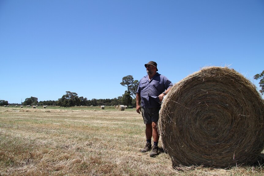 Murray Tucker with one of the many bales of hay cut this week.