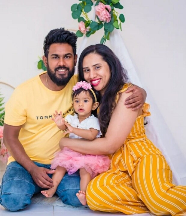 Family portrait of mother, father and young girl.