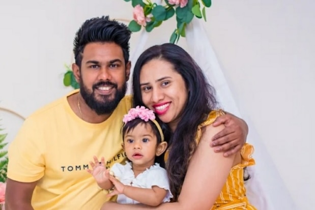 Family portrait of mother, father and young girl.