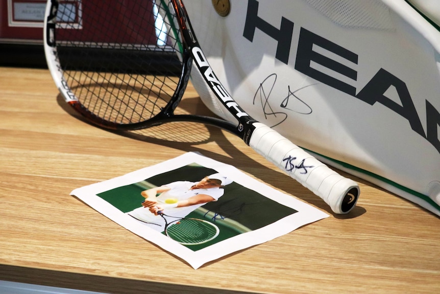 Signed tennis racquet by Ash Barty.