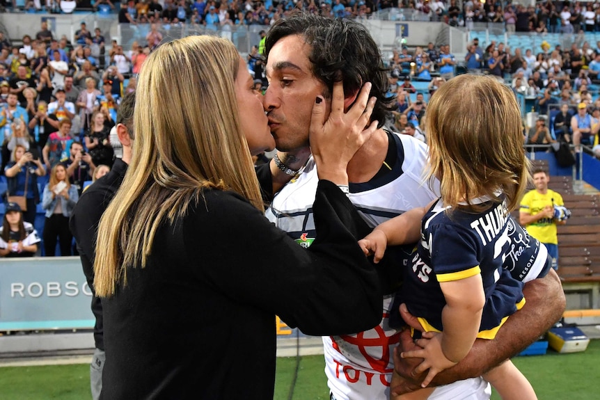Johnathan Thurston kisses his wife Samantha before running on the field for the Cowboys against the Titans.