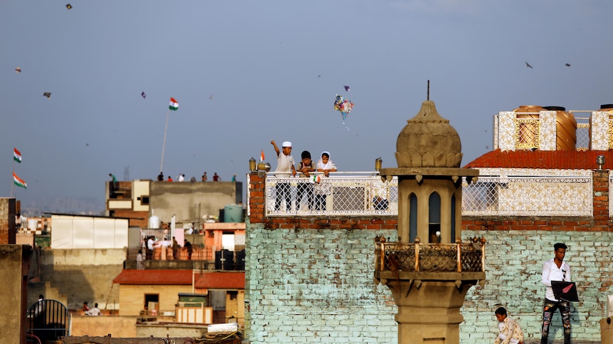 Children fly kites in India