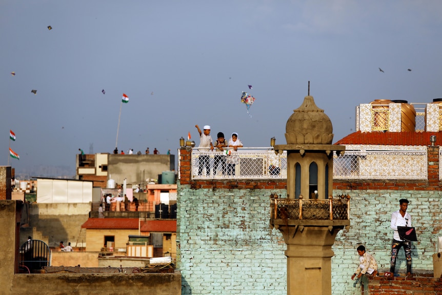 Children fly kites in India