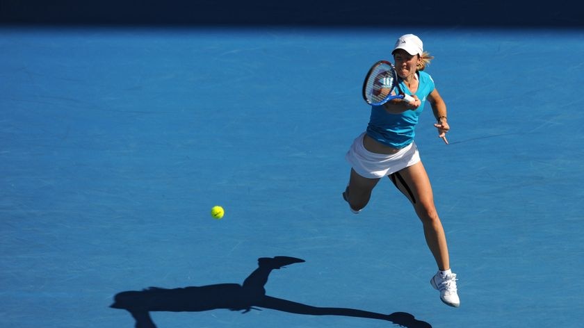 Justine Henin hits a return against Zheng Jie