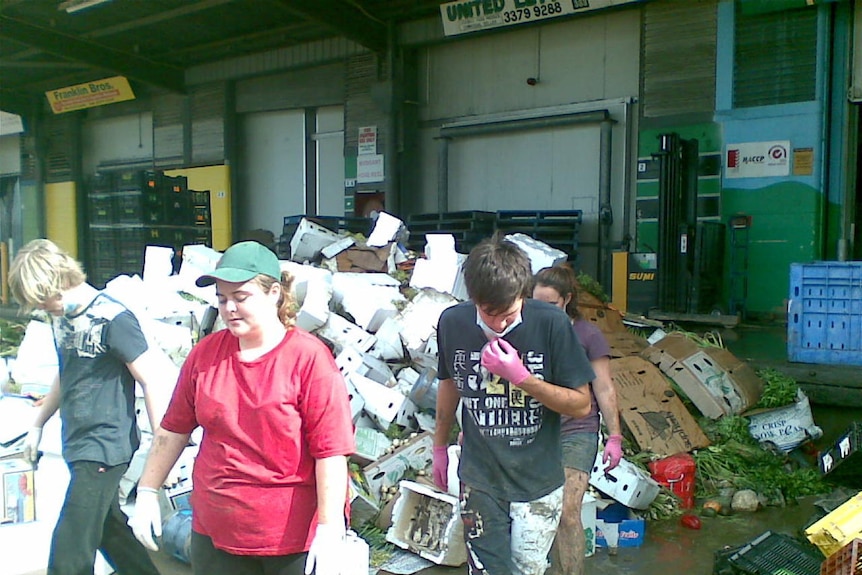 Brisbane residents help clean a business at Rocklea markets