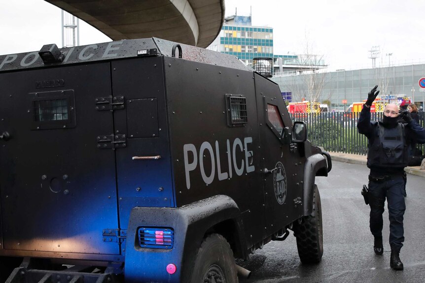 RAID police respond to the situation near the southern terminal of Paris' Orly airport.