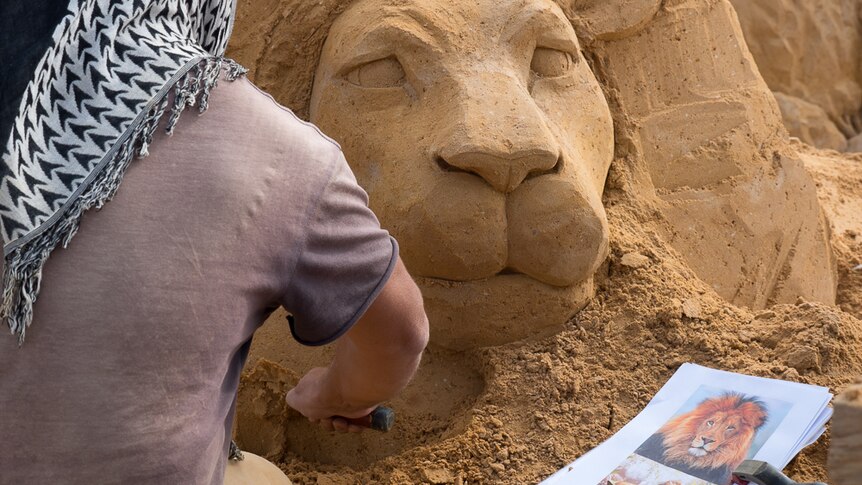 Leo Vamvalis from Melbourne creates a sand lion.