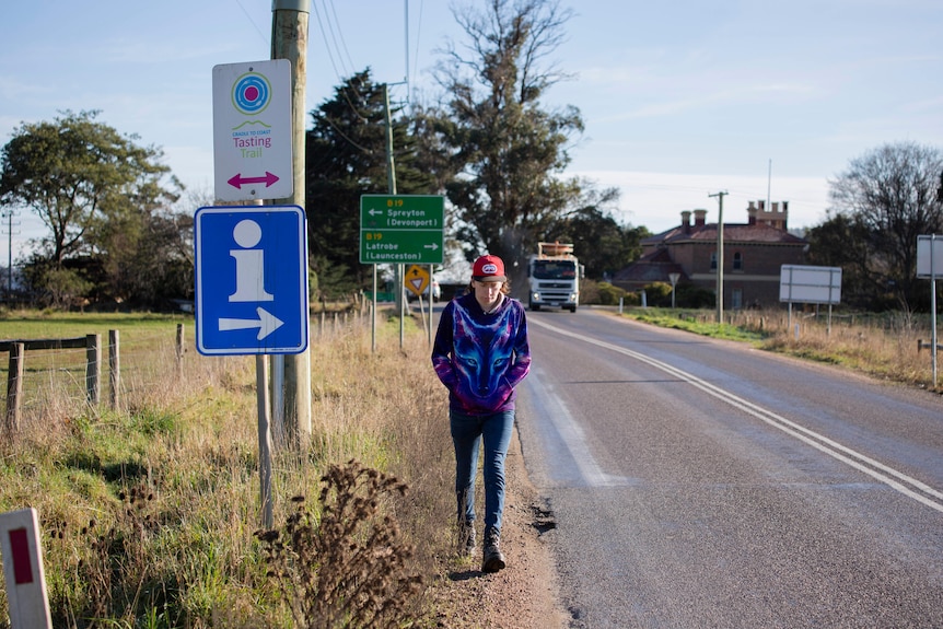 Jacob Foster walks along a busy country road.